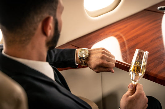 Watch Travel Cases - a businessman sites in a private jet and looks at his watch